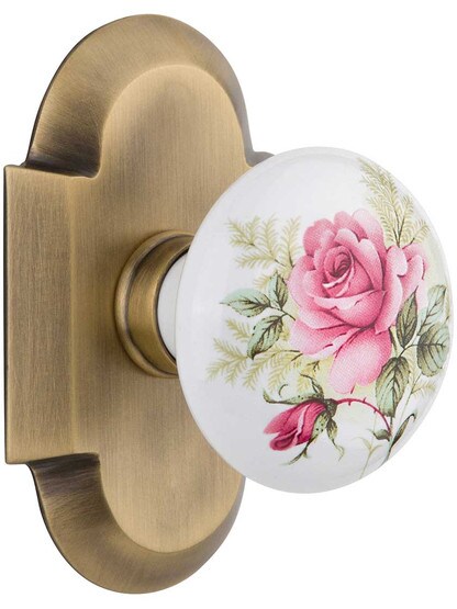 Arched Rosette Door Set with Rose Porcelain Knobs in Antique Brass.